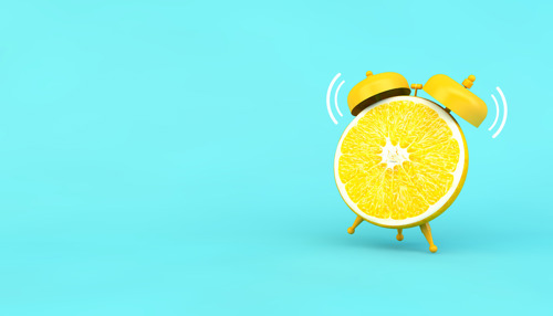 Lemon in the shape of alarm clock as a reminder to take vitamin C during pregnancy.