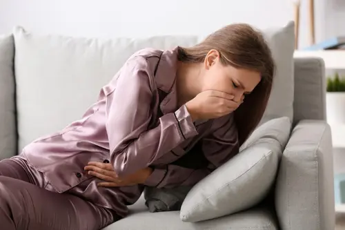 Pregnant woman suffering from nausea at home during pregnancy.