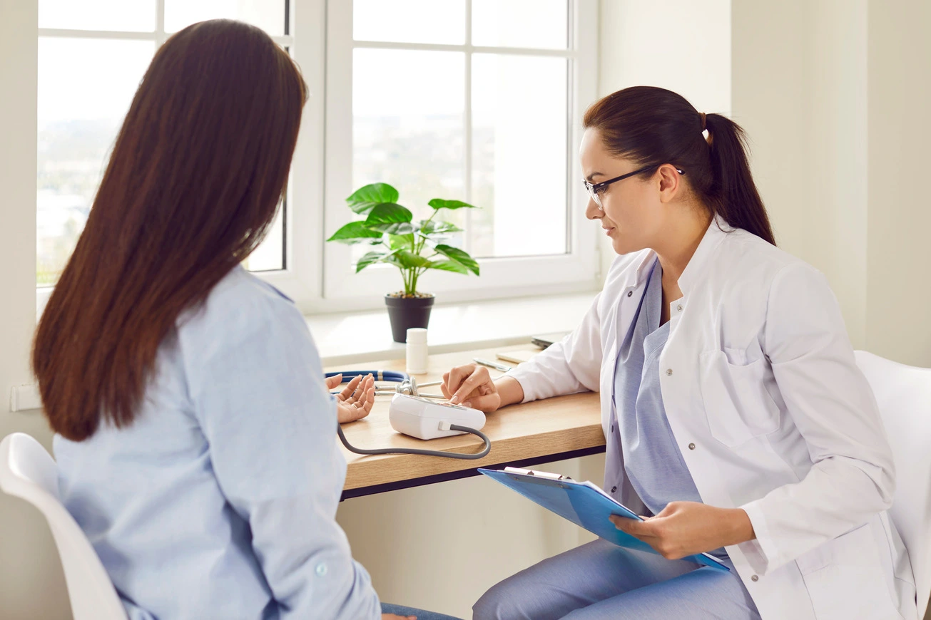 Woman undergoing medical checkup with her doctor.