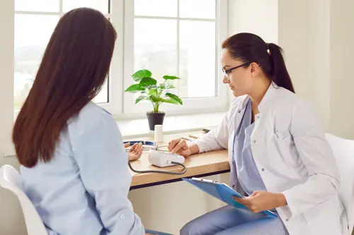 Woman undergoing medical checkup with her doctor.